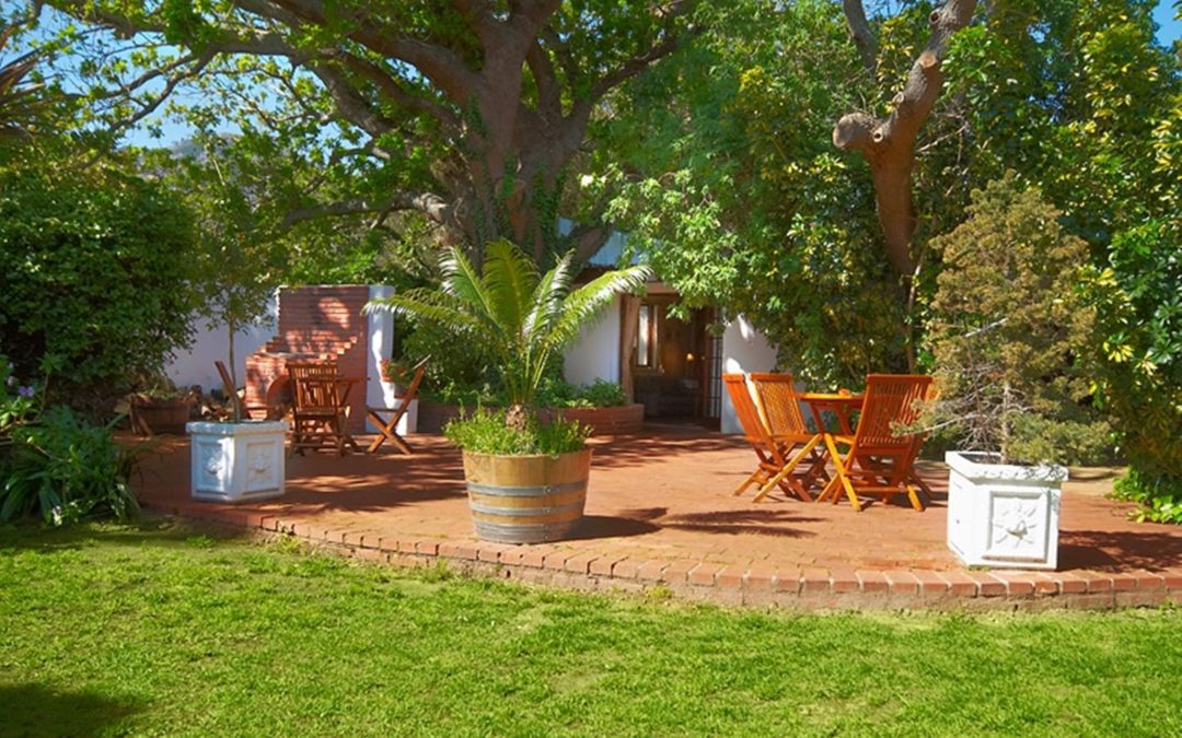 Garden view towards Oak Tree Cottage at Sacred Mountain Lodge, Noordhoek